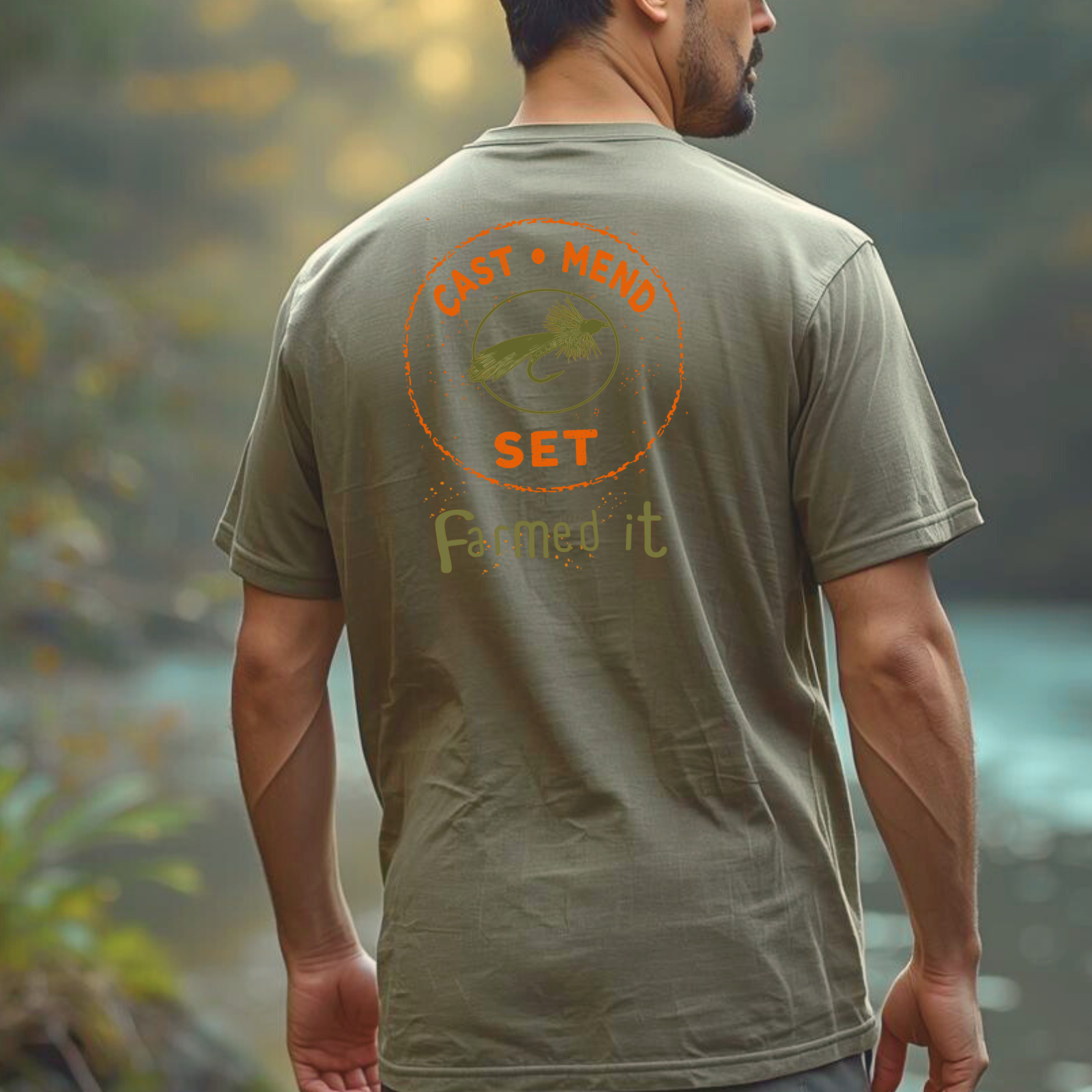 Lifestyle photo of a person wearing a light green t-shirt outdoors (fly fishing graphic tee), relaxed casual fit.