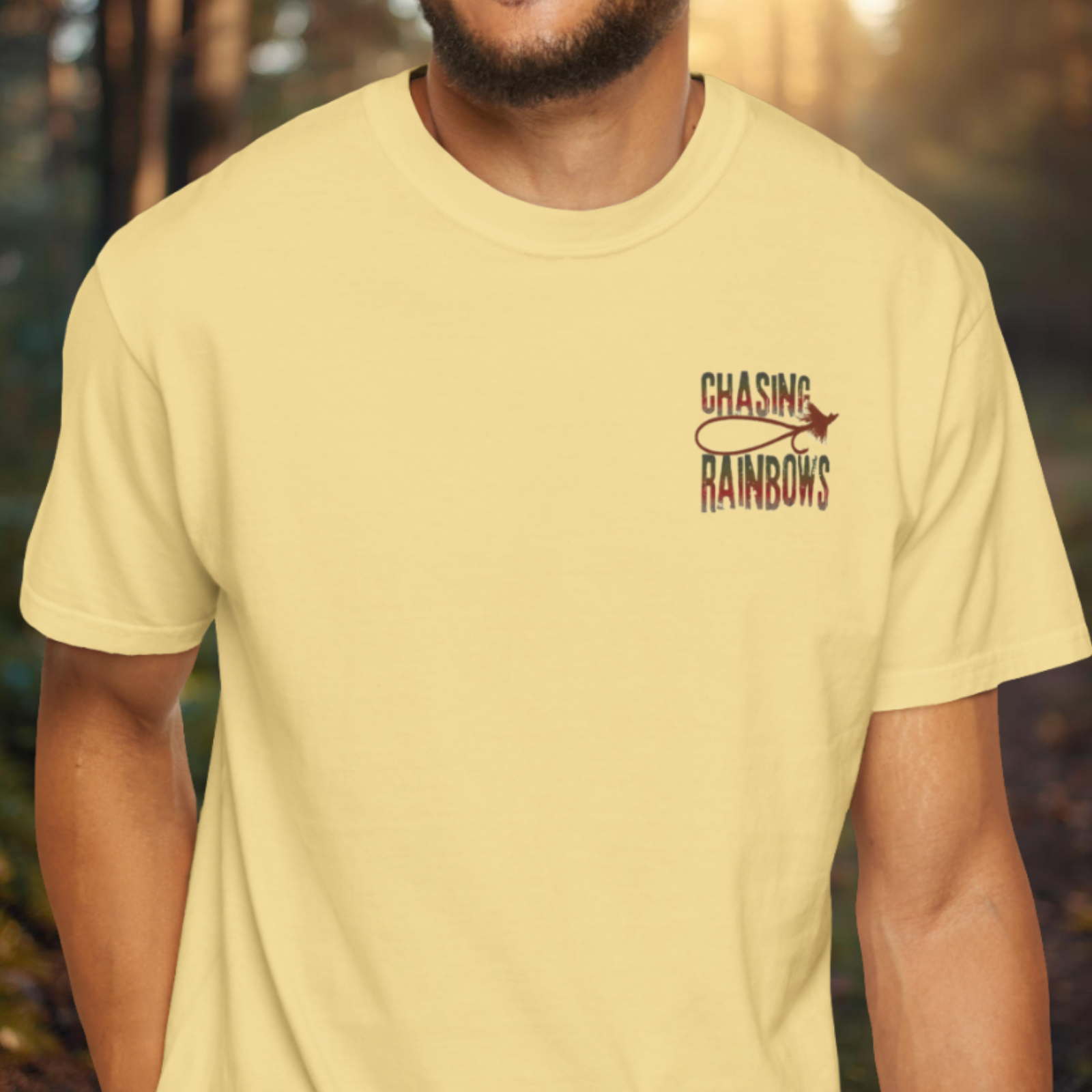 Yellow t-shirt showing small left-chest “Chasing Rainbows” rainbow dry fly emblem.