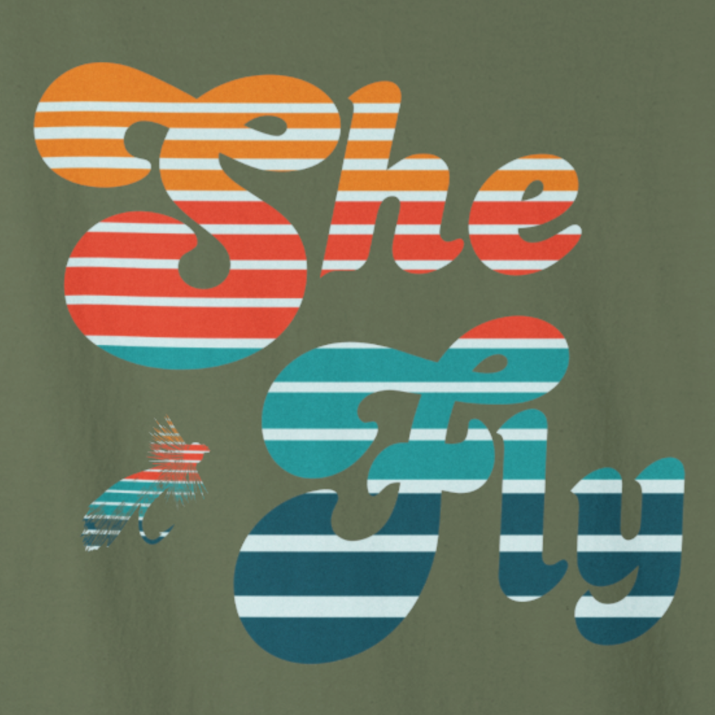 Close-up of the retro striped “She Fly” lettering in warm sunset colors.