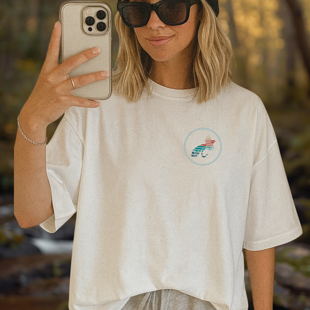 Front view of the “She Fly” tee showing a small chest emblem in vintage style.