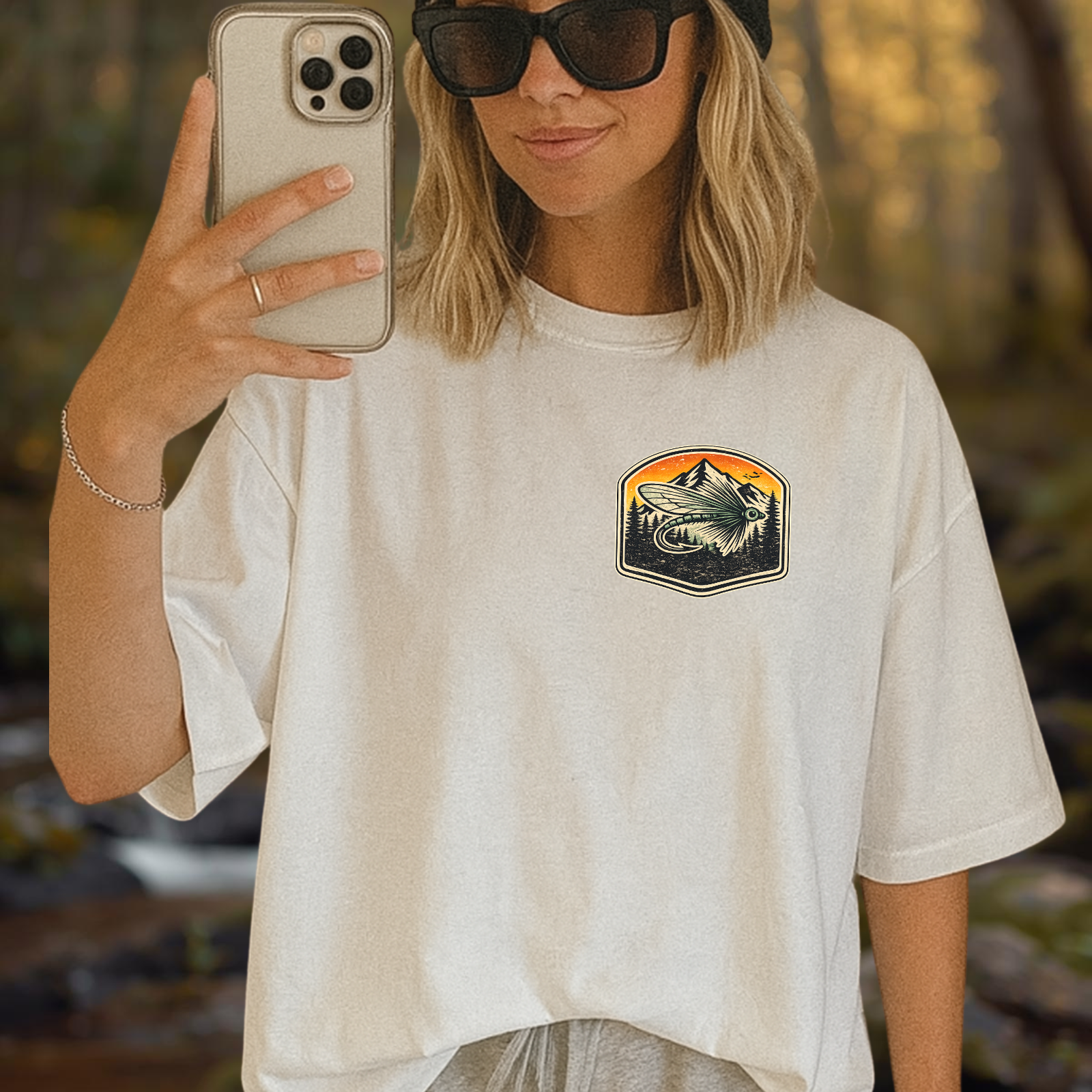 Lifestyle photo of person wearing the tee showing the small front chest badge detail.