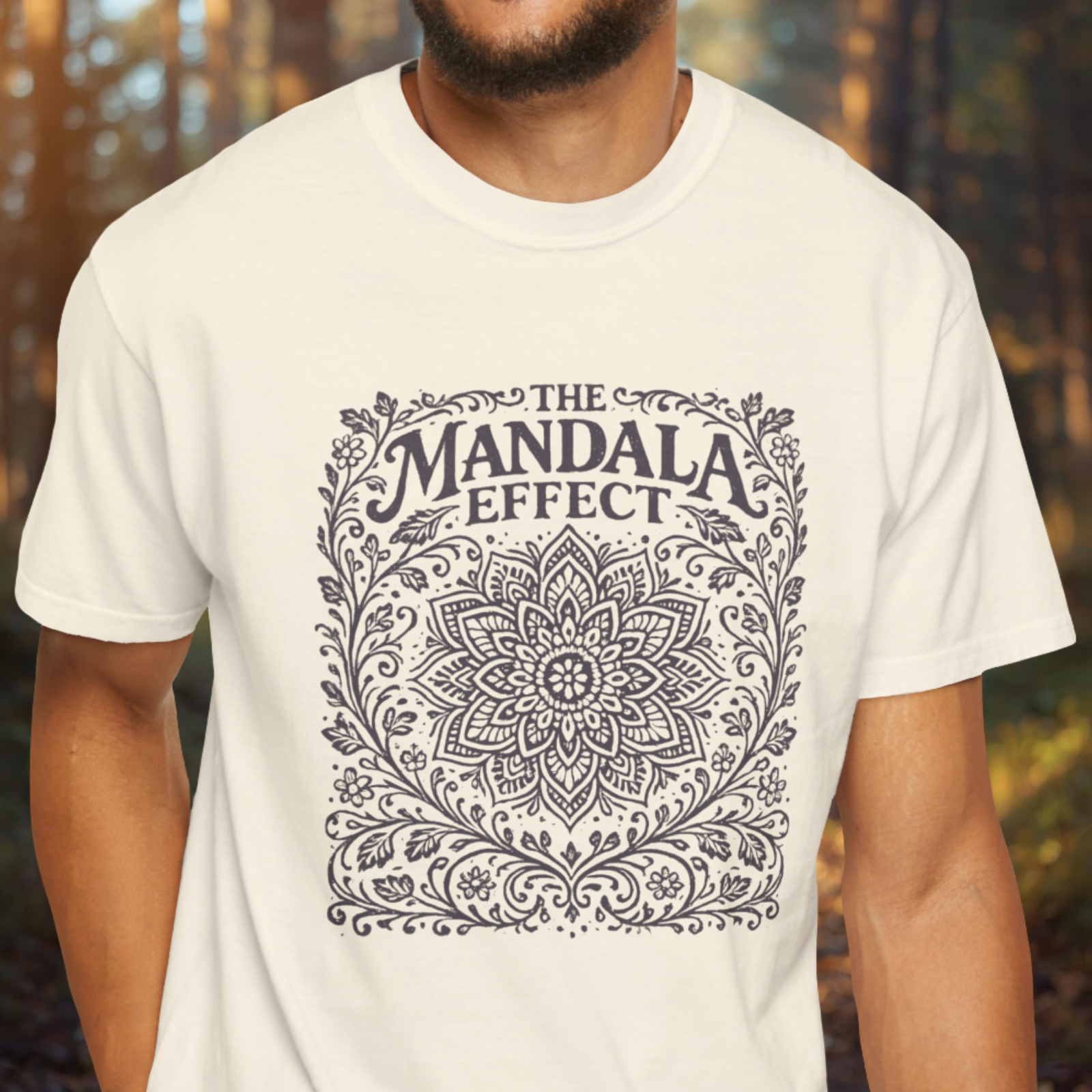 Person wearing a white t-shirt with 'The Mandala Effect' design.