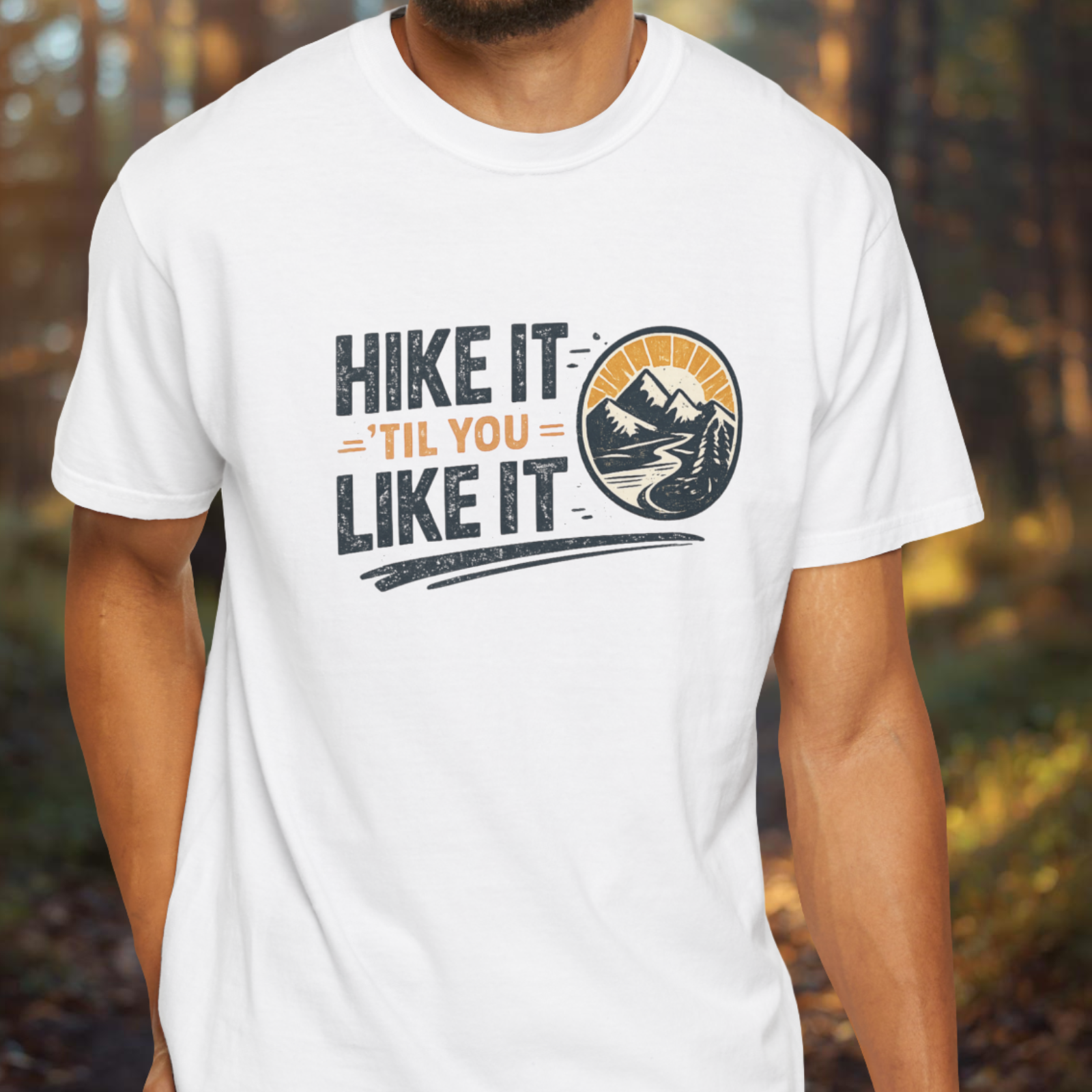 Person wearing a white t-shirt with 'Hike It Til You Like It' text and mountain graphic.