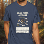 Person wearing a blue t-shirt with 'Trail Mixed Opinions' design in a forest setting