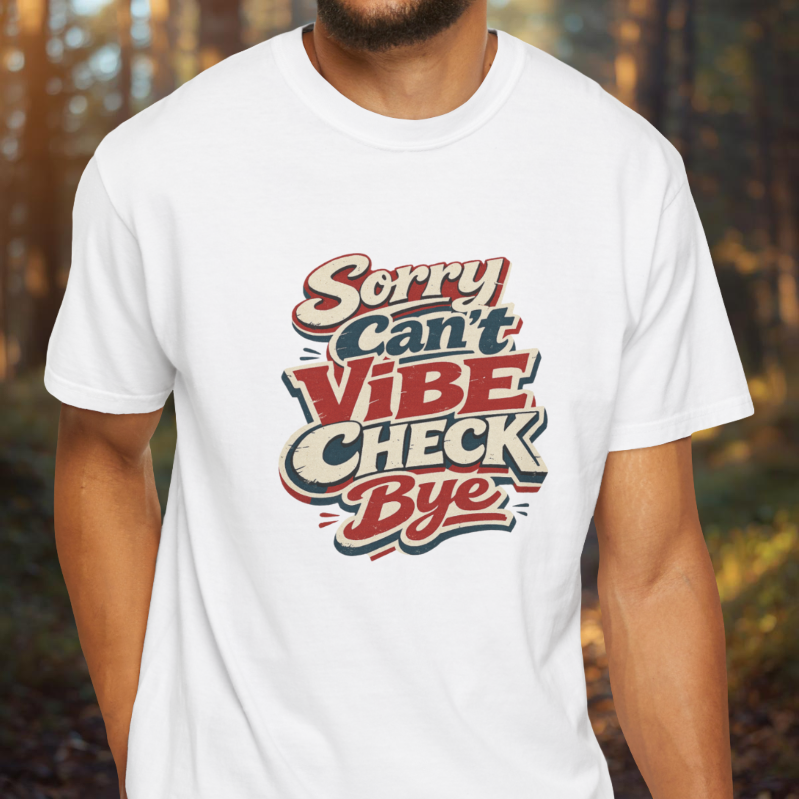 Person wearing a white t-shirt with colorful text design in a forest setting