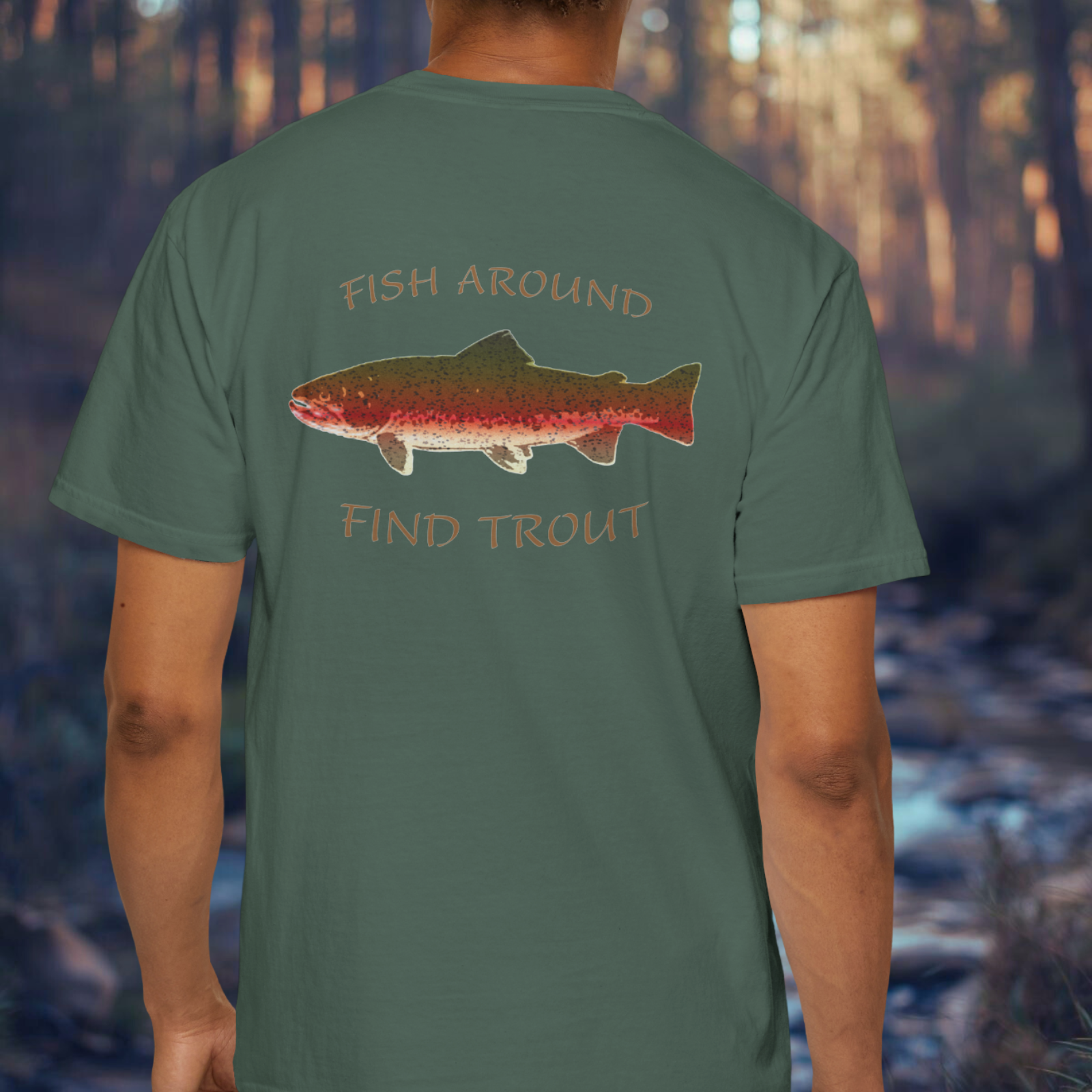 Person wearing a green t-shirt with a fish graphic and text in a forest setting