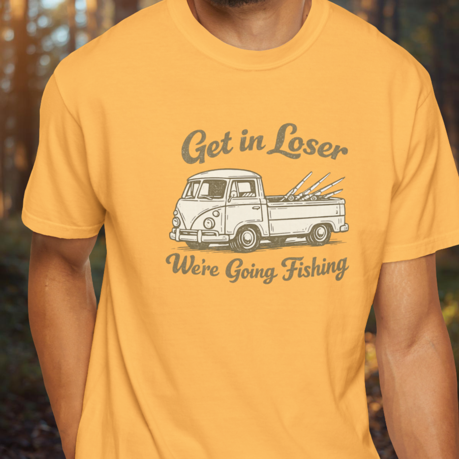 Person wearing a citrus yellow t-shirt with a graphic of a van and text 'Get in Loser, We're Going Fishing'.