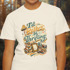 White t-shirt with 'I'd Rather Be Thrifting' graphic design featuring vintage items.