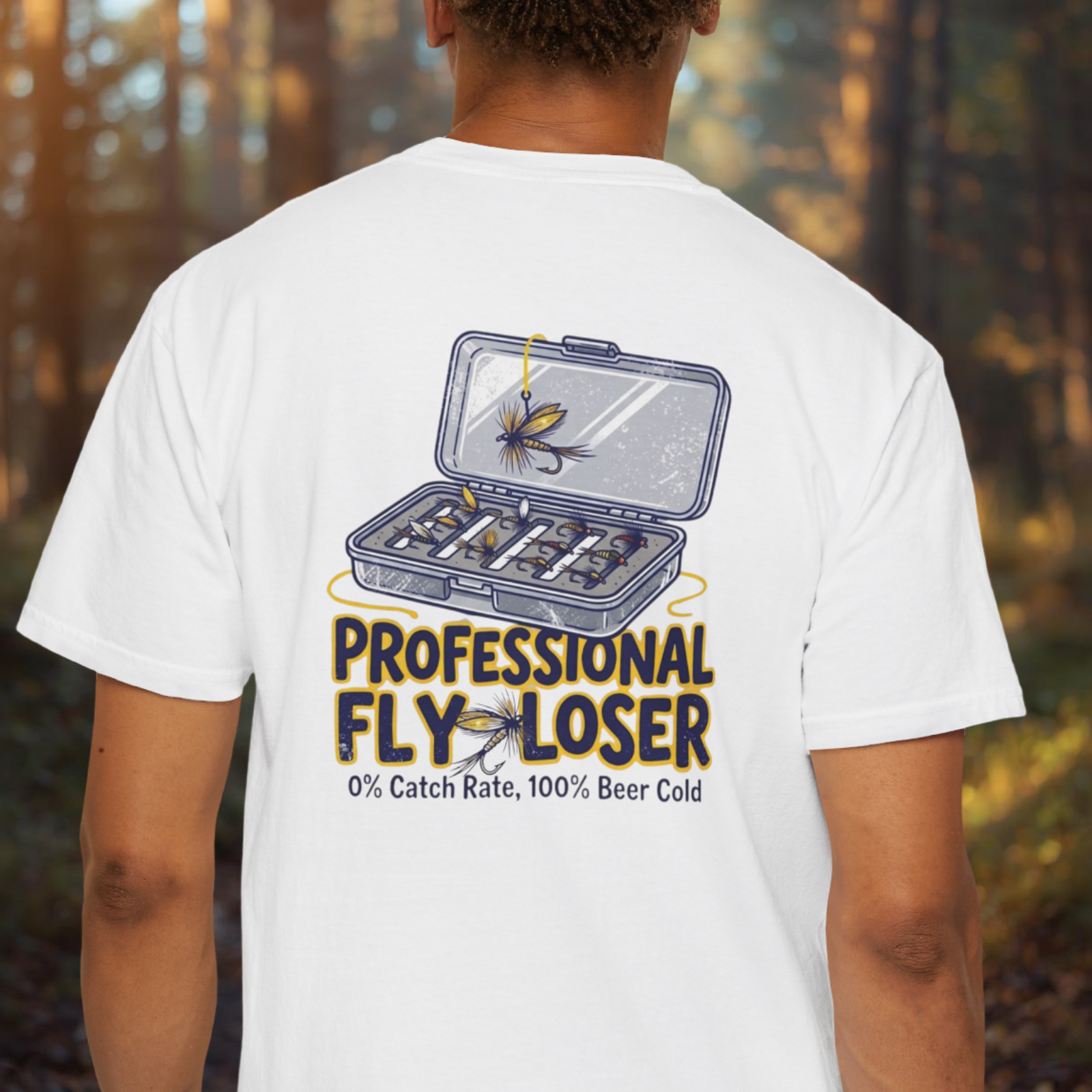 Person wearing a white t-shirt with a fishing-themed design and text in a forest setting