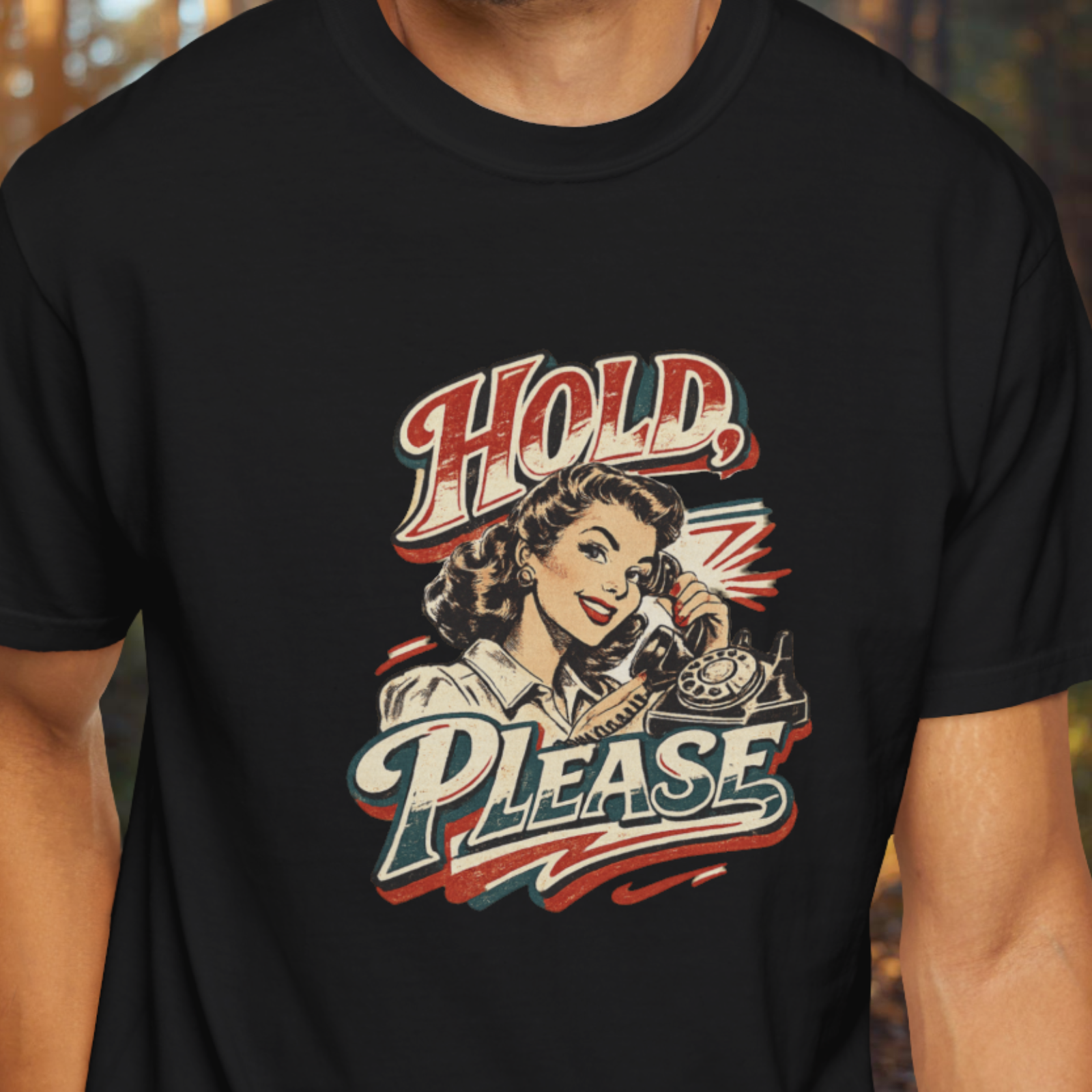 Black t-shirt with vintage-style graphic of a woman on the phone and 'Hold, Please' text.