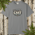 Gray t-shirt with 'Just One More Cast' fishing graphic on a wooden background