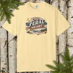 Flat lay of My Feral Heart graphic tee showing rustic river-and-pines illustration.