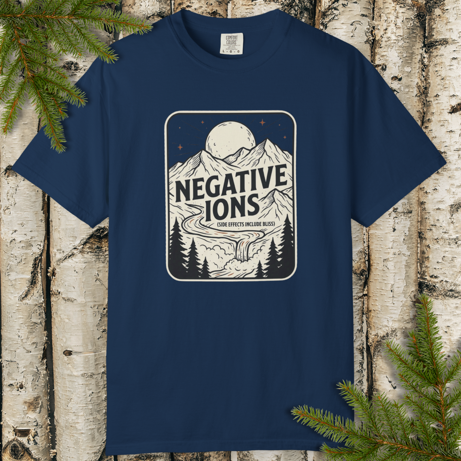 Negative Ions Side Effects Include Bliss graphic t-shirt flat lay with vintage outdoors badge design.