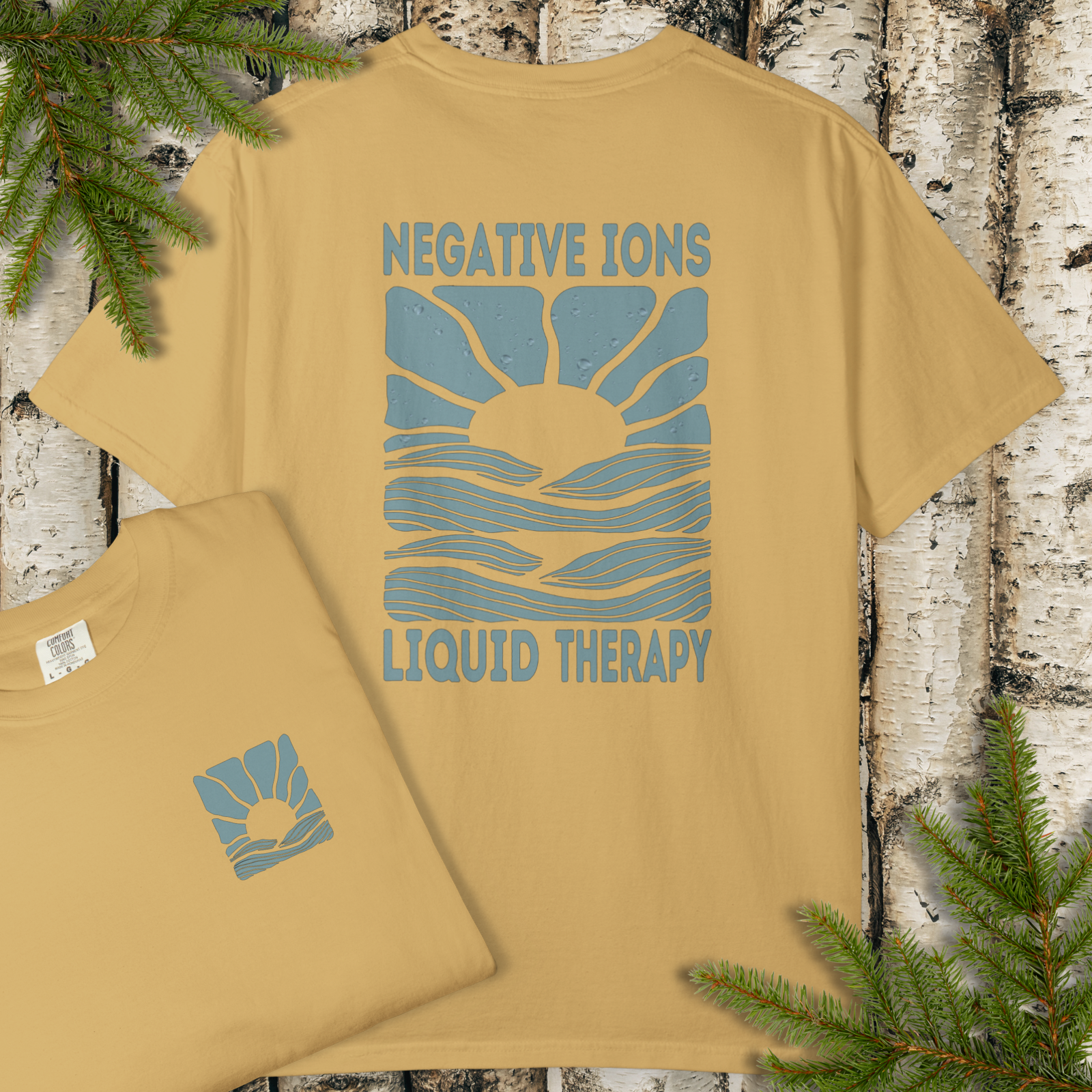 Negative Ions Liquid Therapy t-shirt flat lay showing retro sunrise and water graphic.