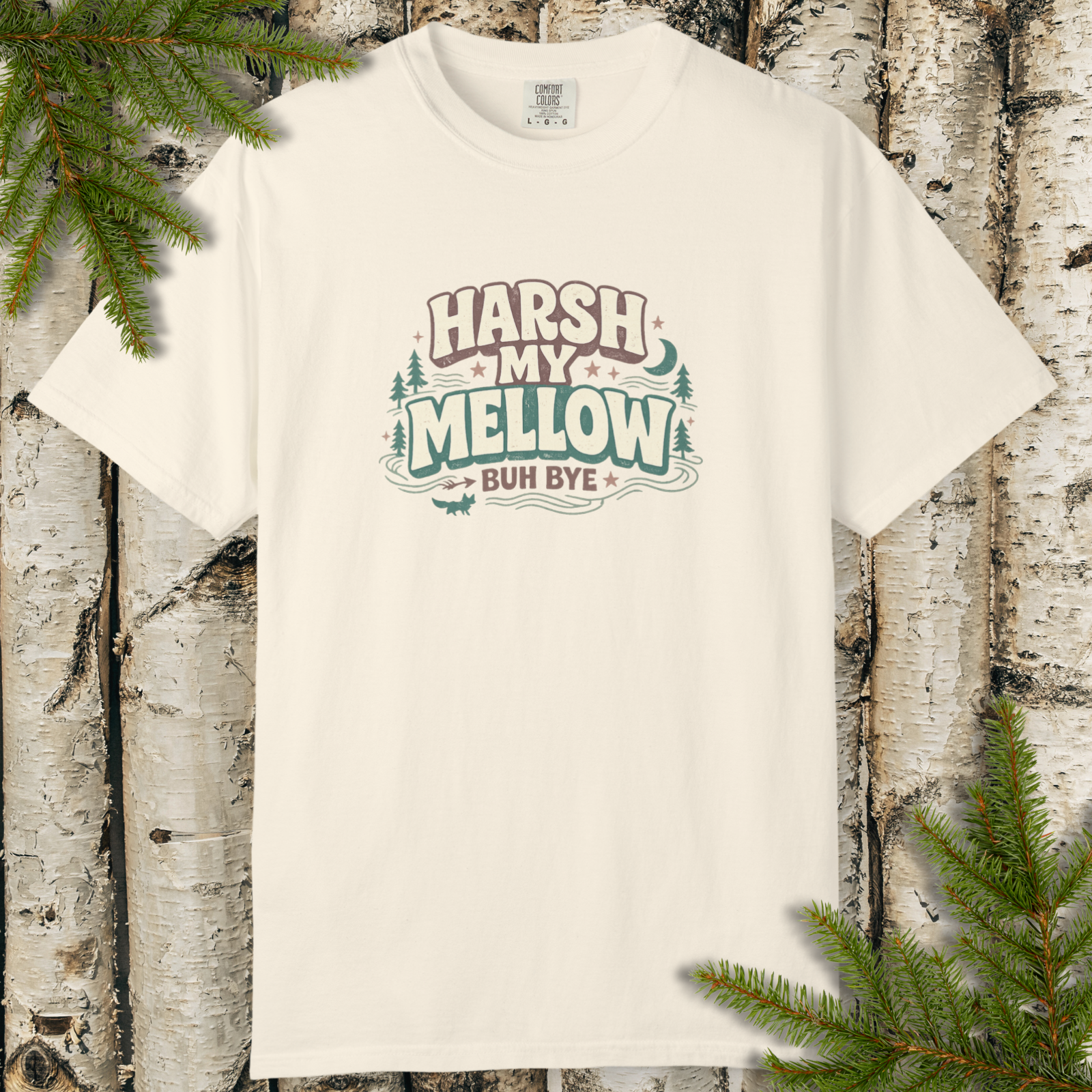 White t-shirt with 'Harsh My Mellow Buh Bye' text design on a wooden background with greenery.