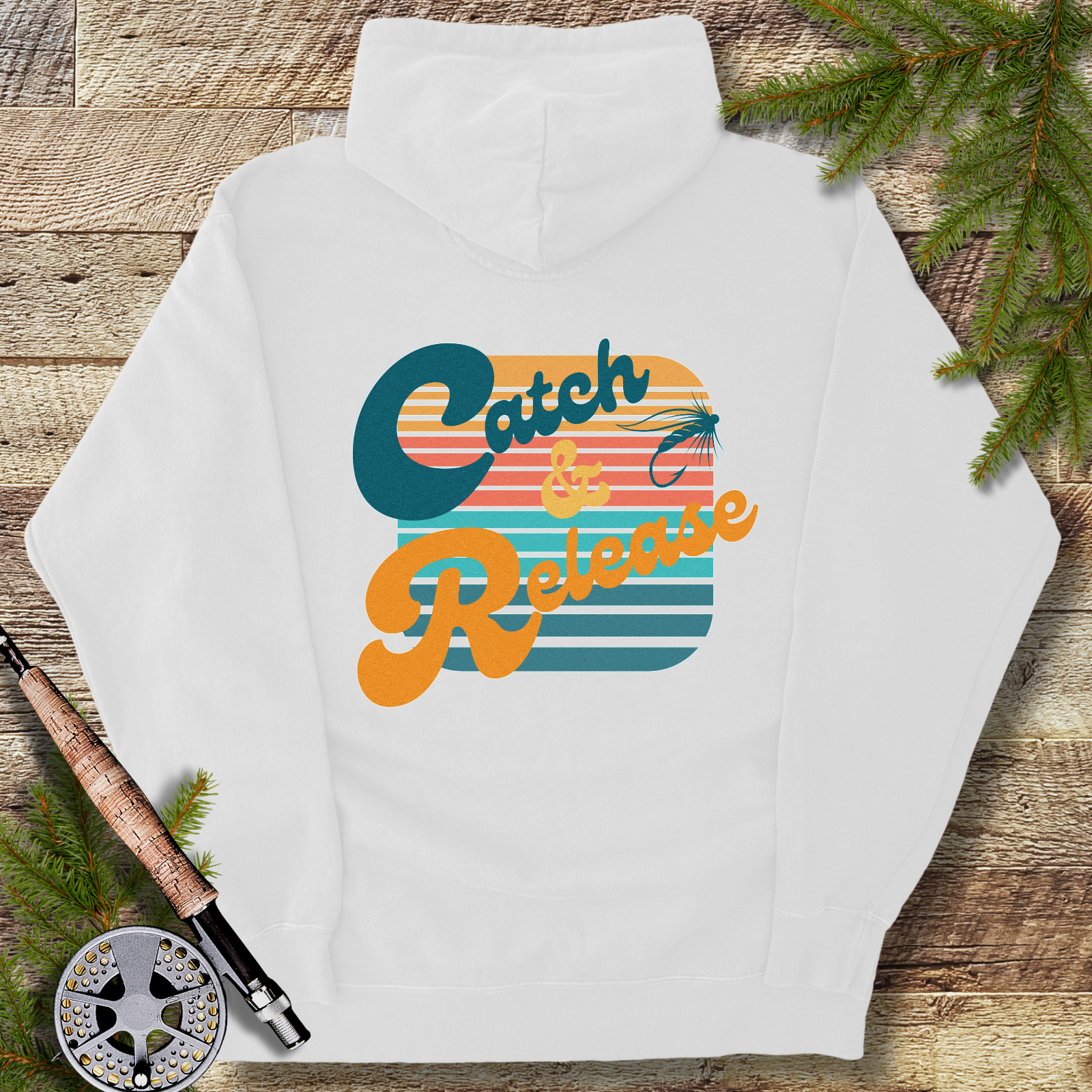 White heavyweight hoodie with large retro “Catch & Release” fly fishing graphic in sunset stripes.