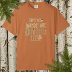 Brown/rust garment-dyed t-shirt with “Some Who Wander Are Definitely Lost” hand-lettered graphic on the front.