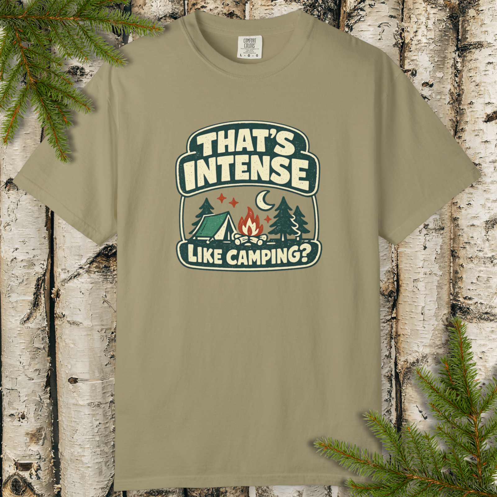 Khaki t-shirt with funny retro camping graphic reading “That’s Intense Like Camping?” with campfire and forest design