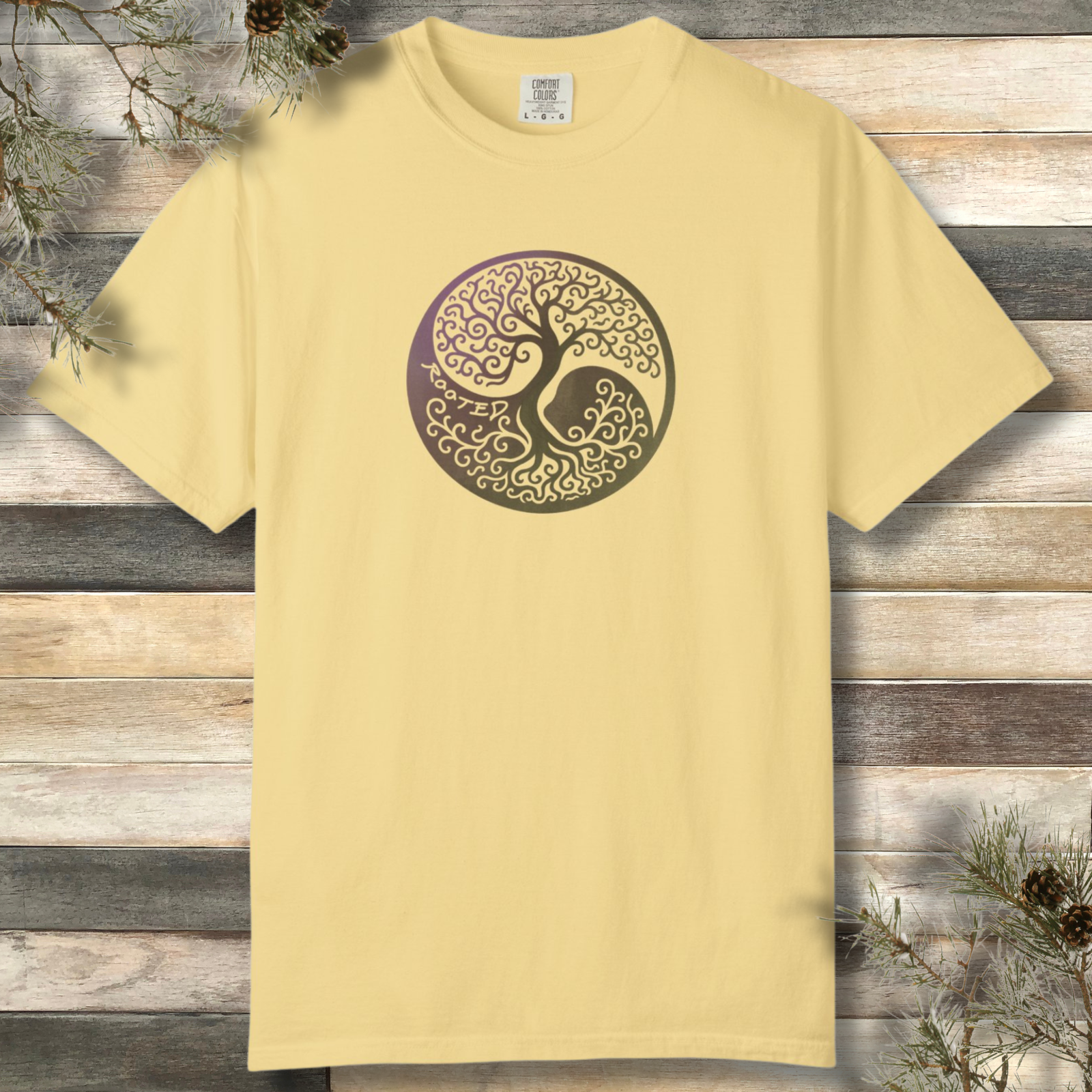 Yin yang tree with ‘Rooted’ text on nature inspired yellow t-shirt
