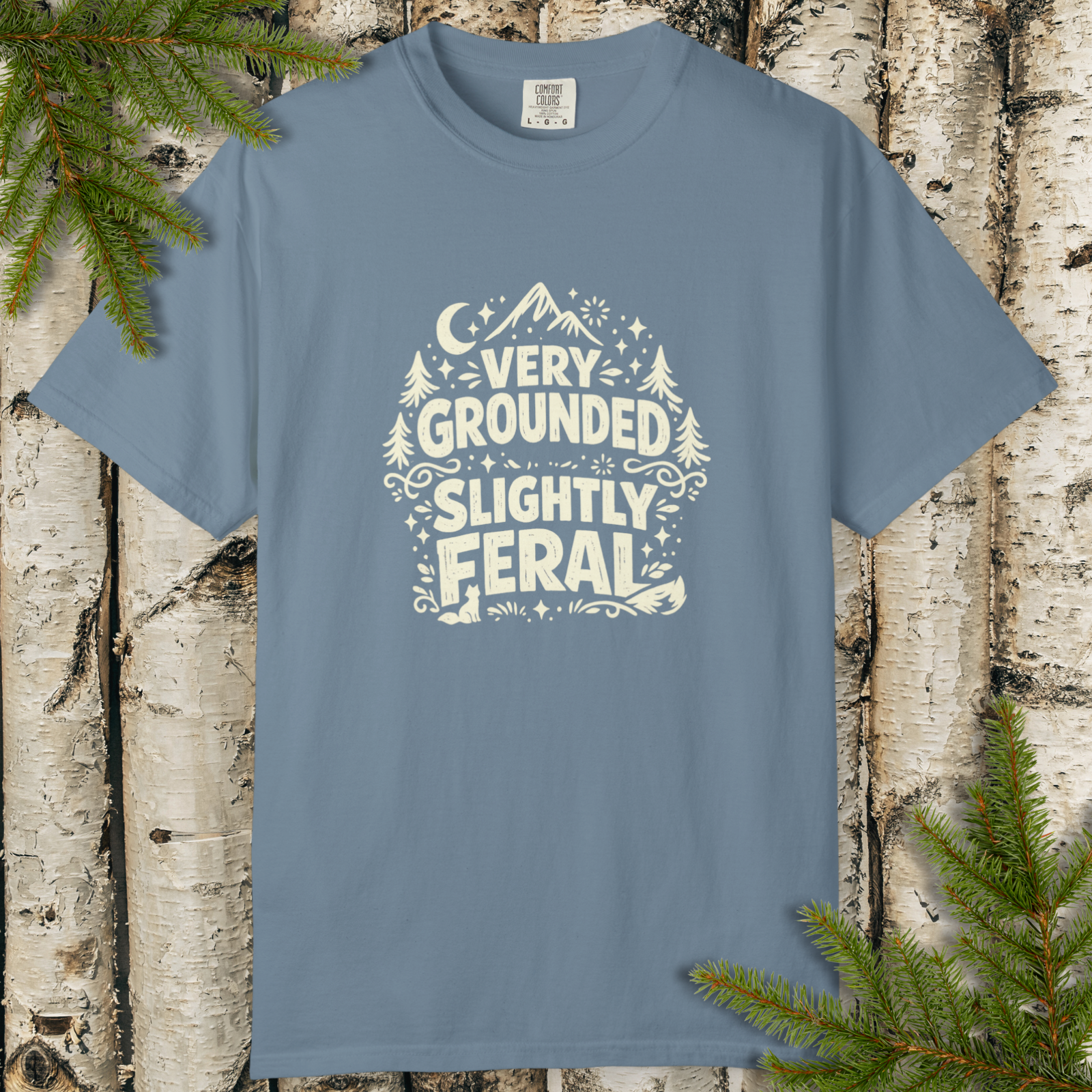 Very Grounded Slightly Feral retro outdoor graphic t-shirt displayed on a flat lay.