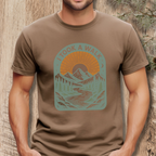 Person wearing a brown t-shirt with a graphic design and text 'I took a walk' against a wooden background.