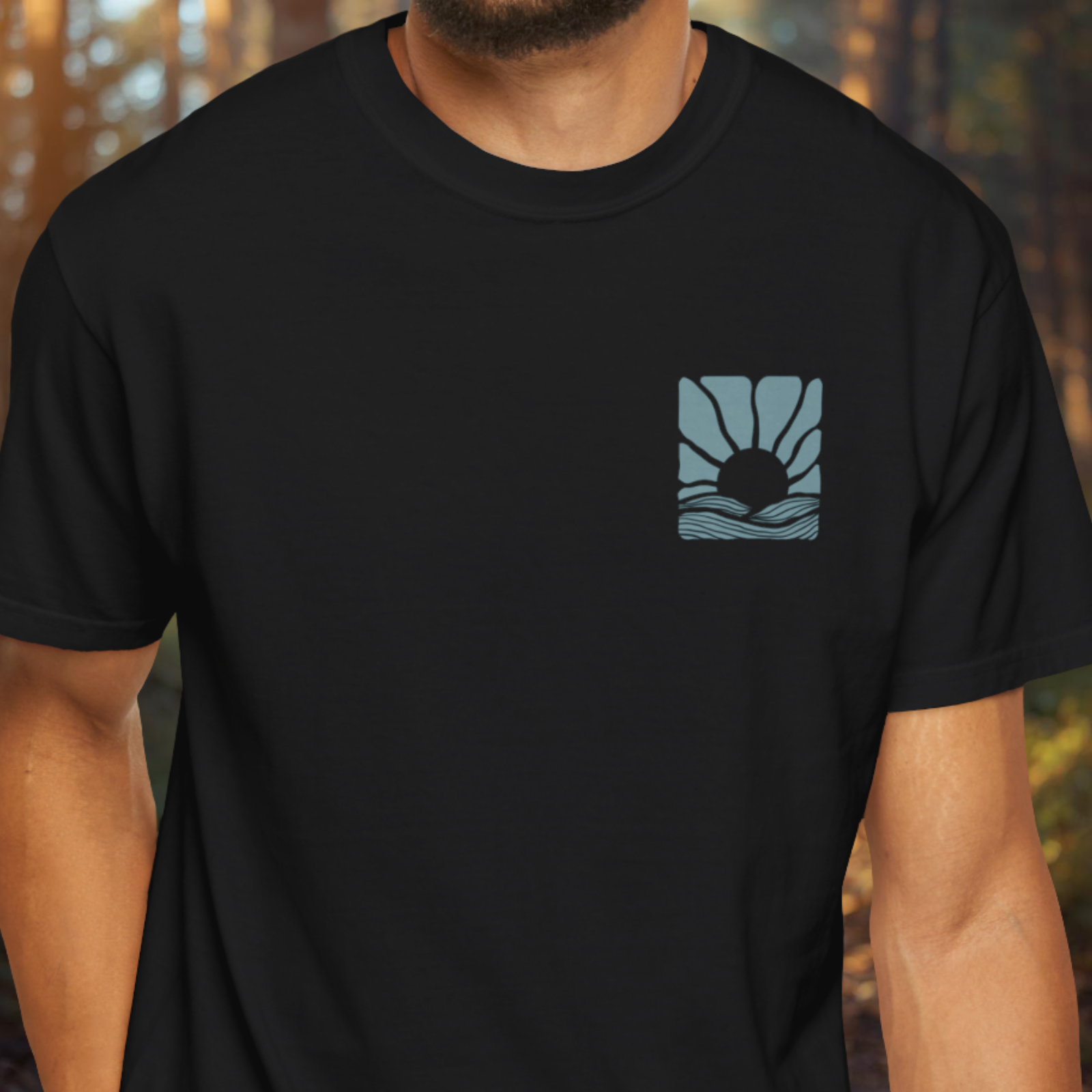 Model wearing Negative Ions Liquid Therapy shirt with small chest graphic.