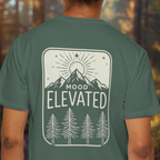 Model wearing Mood Elevated tee showing back print mountain sunrise design.