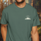 Model wearing Mood Elevated t-shirt with small mountain emblem on front chest.