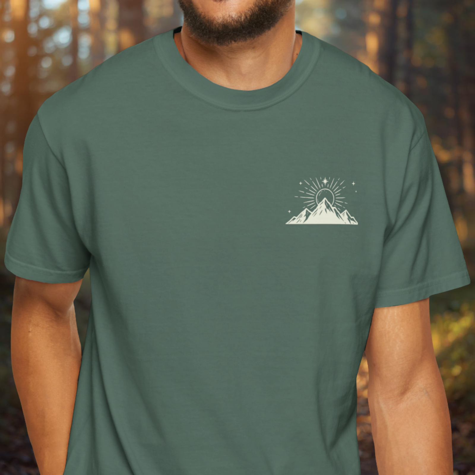 Model wearing Mood Elevated t-shirt with small mountain emblem on front chest.