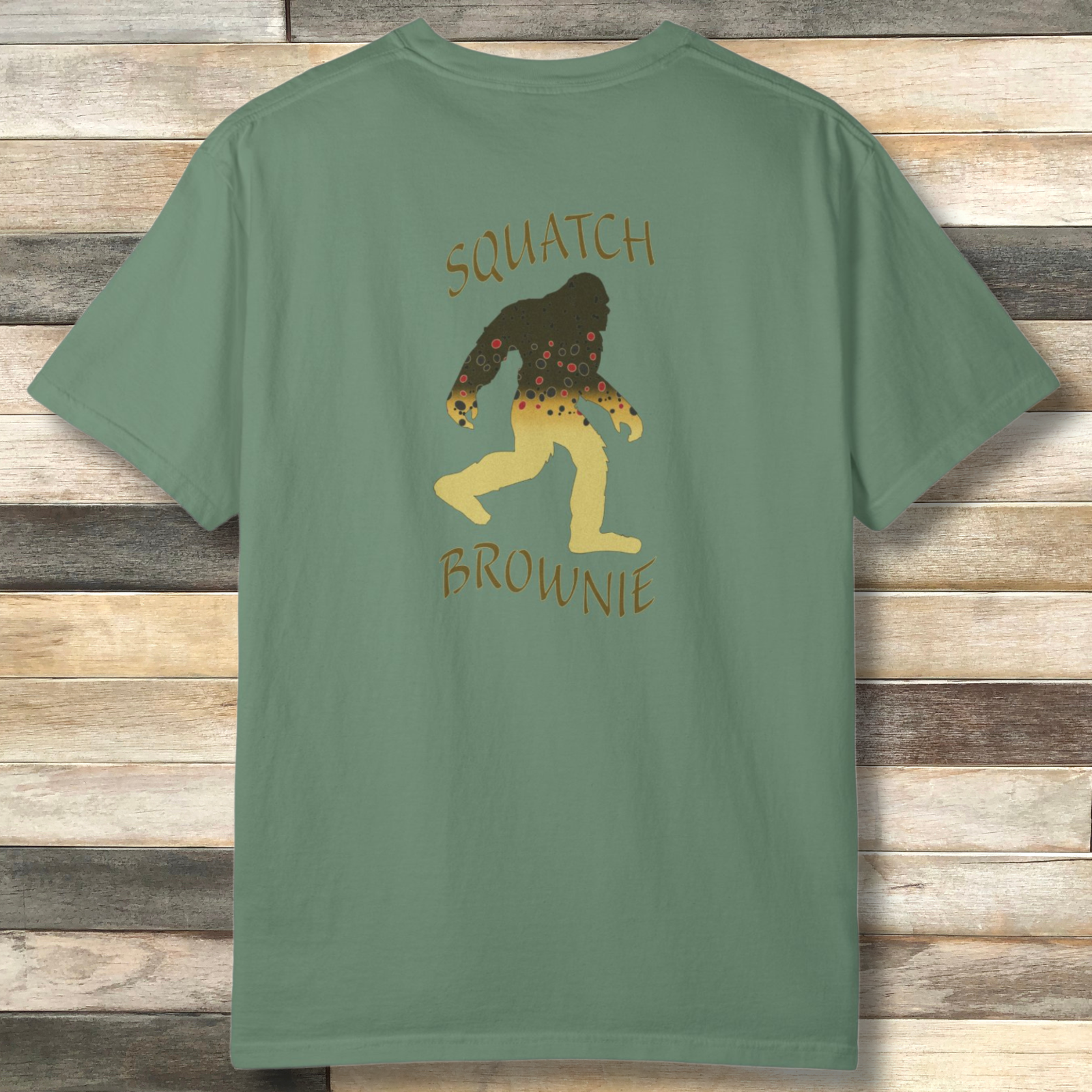 'Squatch Brownie' Bigfoot silhouette filled with brown trout pattern on a light green graphic t-shirt