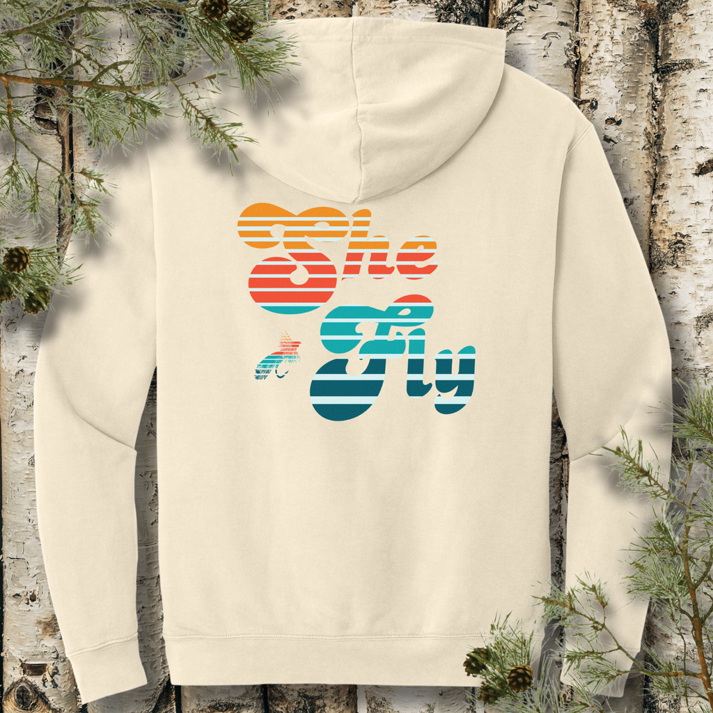 Back view of ivory lightweight hoodie with large retro striped “She Fly” lettering, a women’s fly fishing graphic.
