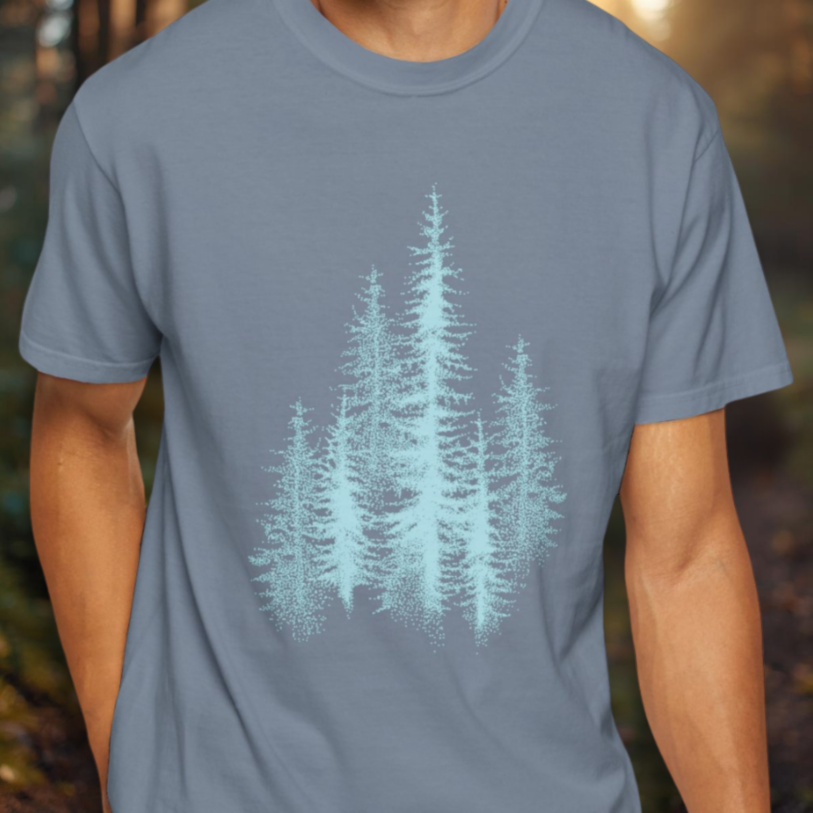 Person wearing a blue t-shirt with a light blue tree graphic