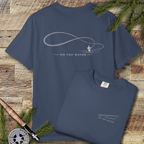 Back and folded front of midnight-colored Comfort Colors t-shirt with minimalist fly fishing line art and “On The Water" text