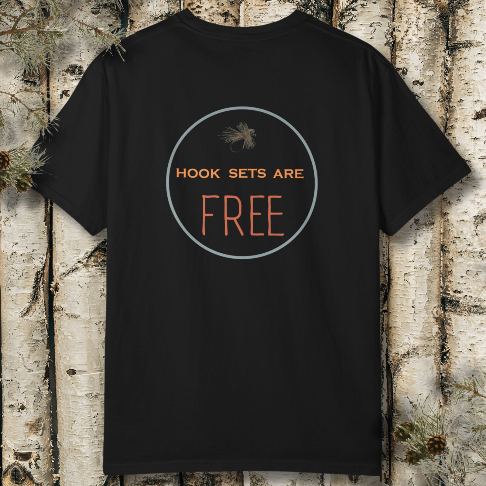 Black t-shirt with 'HOOK SETS ARE FREE' text on a wooden background