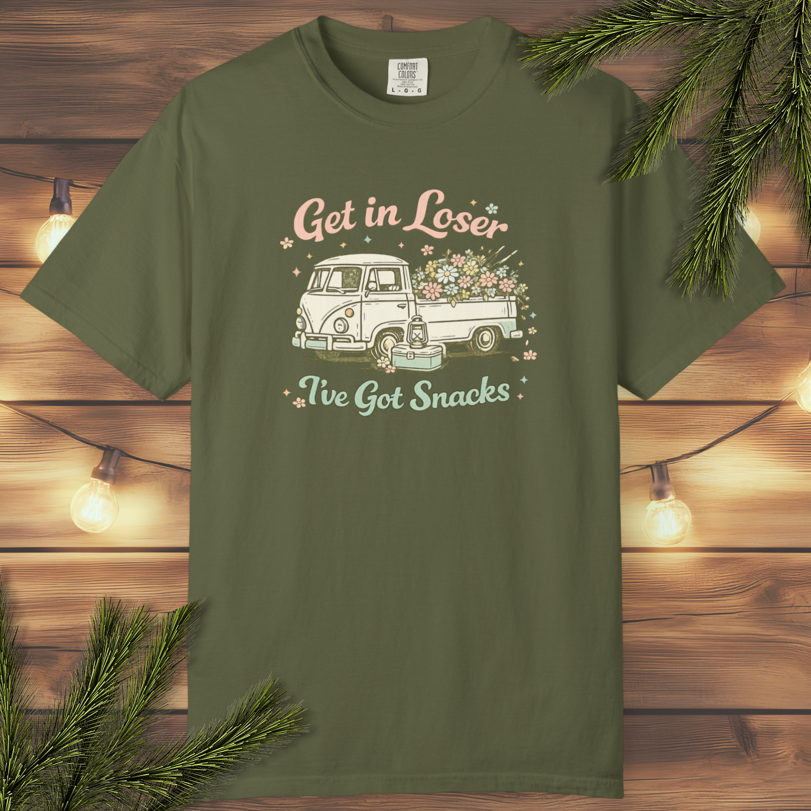 Retro graphic t-shirt featuring a vintage flower truck and the phrase “Get In Loser, I've Got Snacks” in a nostalgic road trip design.