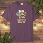 Retro graphic t-shirt with the phrase “Will Crash Out Without Snacks” in playful vintage lettering on a garment-dyed tee.