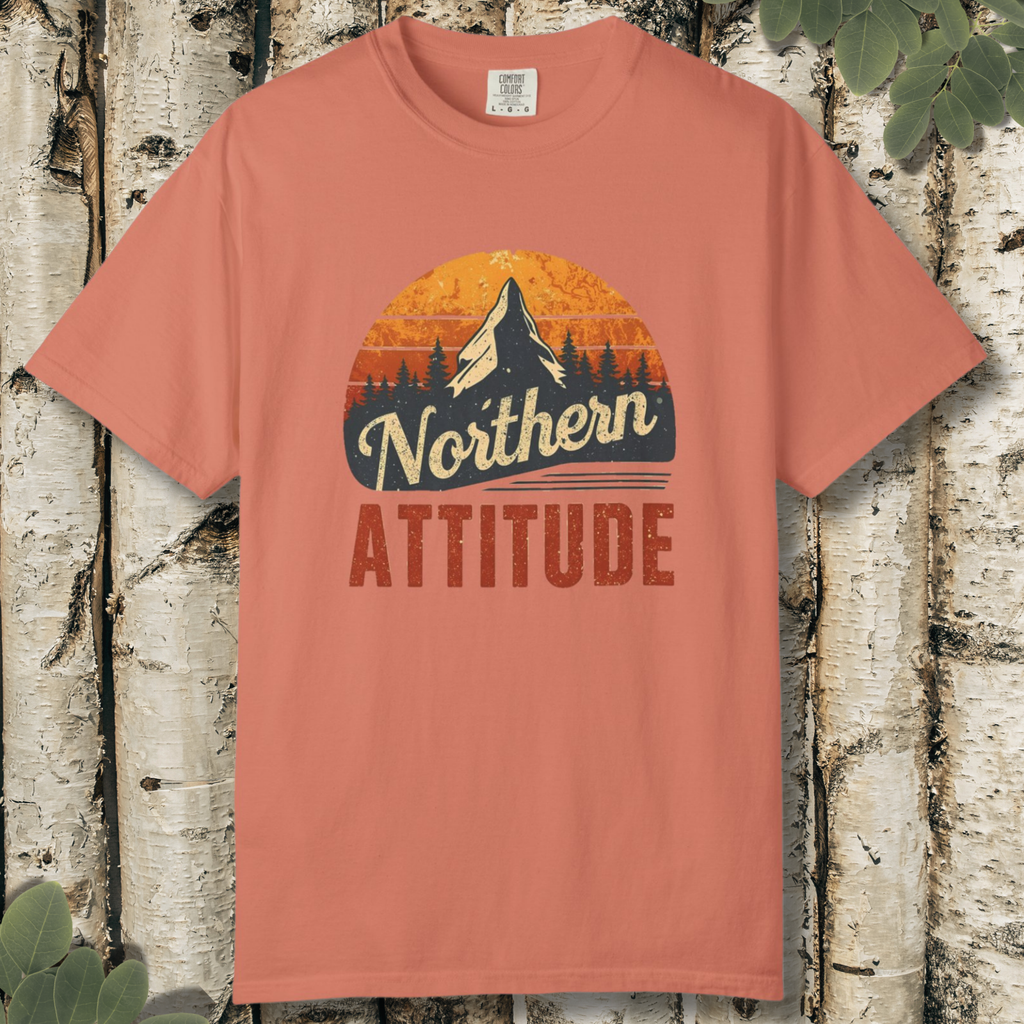 Terracotta unisex t-shirt with “Northern Attitude” retro mountain sunset graphic laid flat on a wooden background.