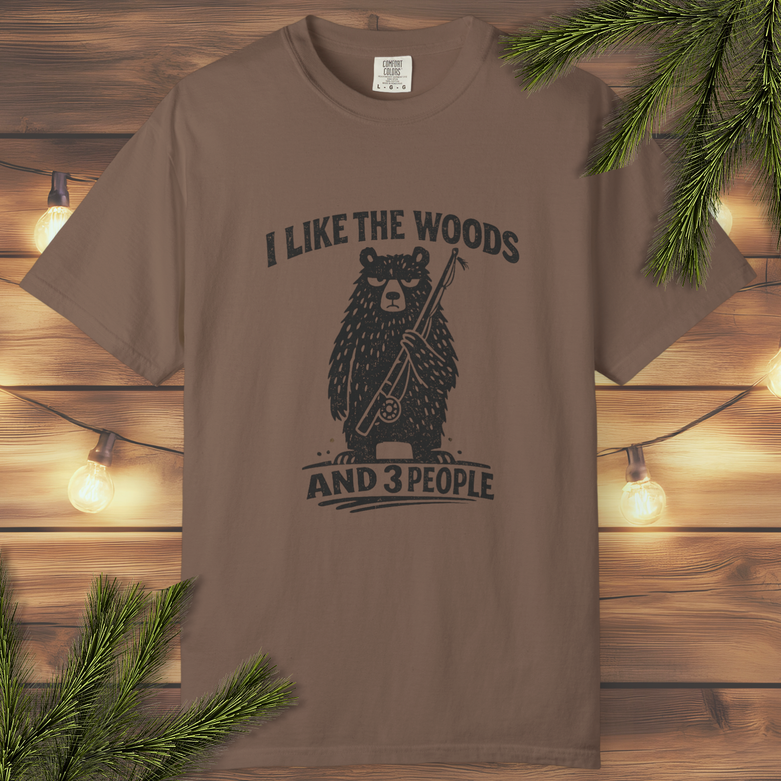 Espresso t-shirt with bear graphic and text 'I Like the Woods and 3 People' on a wooden background.
