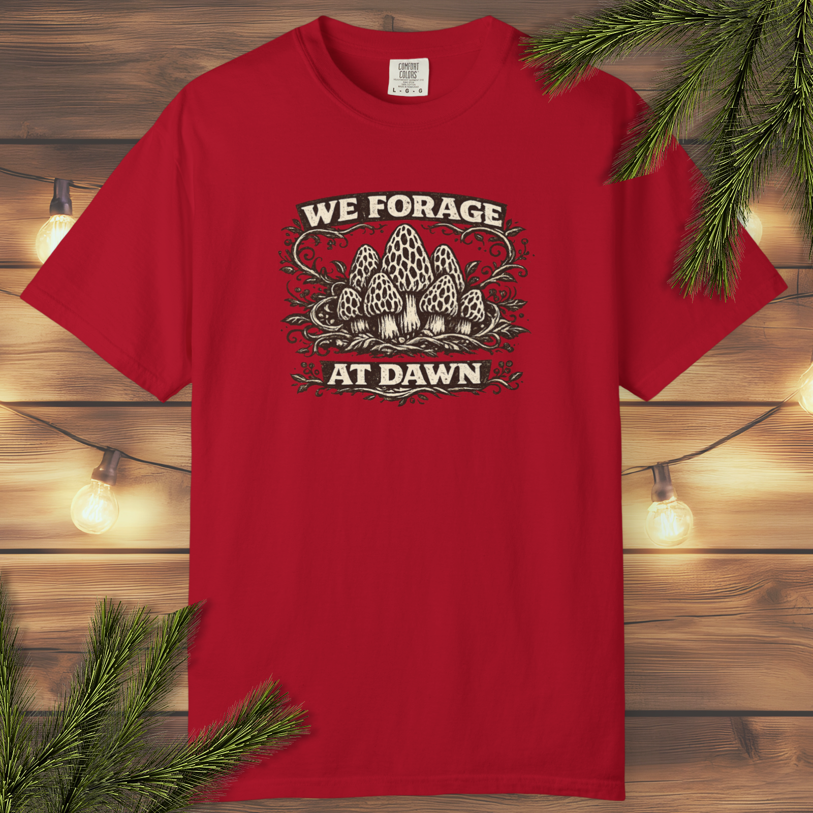 Vintage “We Forage at Dawn” mushroom foraging graphic t-shirt with detailed woodland mushroom illustration in a distressed outdoor style